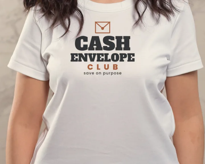 Woman wearing a white "Cash Envelope Club" tee in front of a marble wall