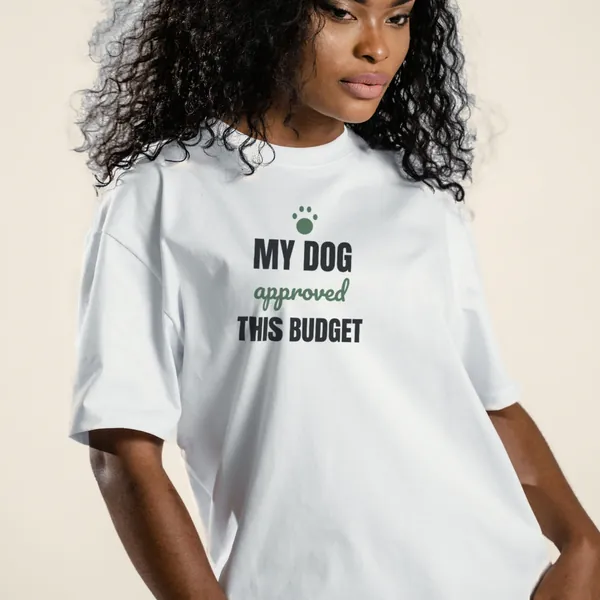 Model wearing a white "My Dog Approved This Budget" graphic tee, front view
