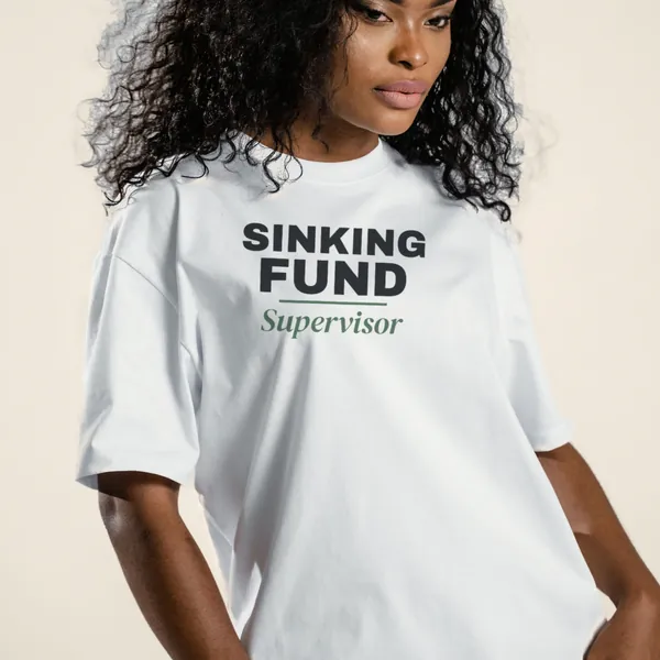 Model wearing a white "Sinking Fund Supervisor" graphic tee, front view