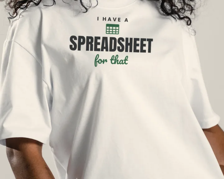 Woman wearing a white "I Have a Spreadsheet for That" tee in a warm studio