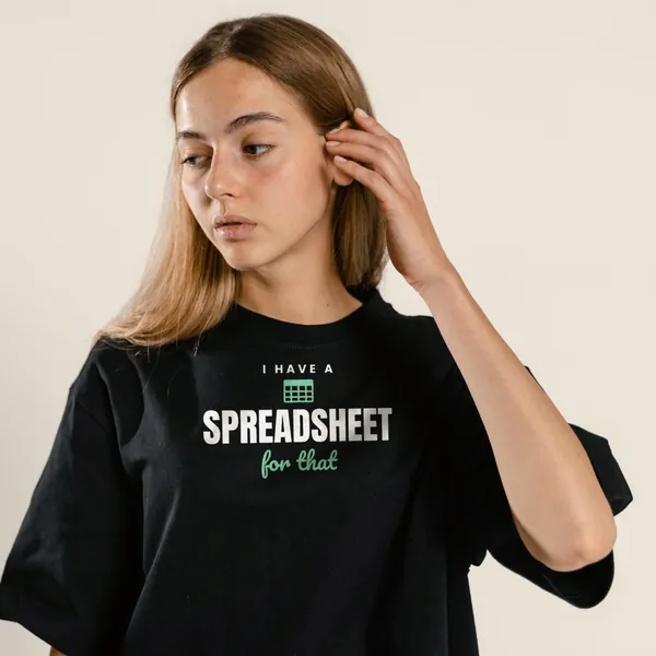 Model wearing a black "I Have a Spreadsheet for That" tee with the light-ink version of the design