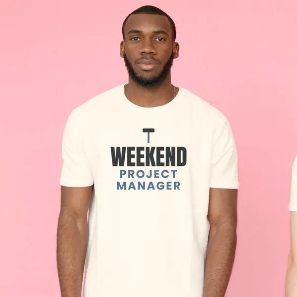 Man wearing a white "Weekend Project Manager" tee against a pink backdrop